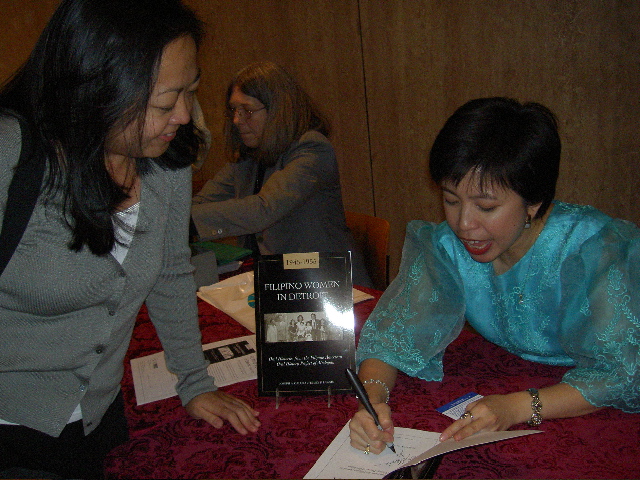 Emily Lawsin signs books after her speech at the Smithsonian, Oct 2004